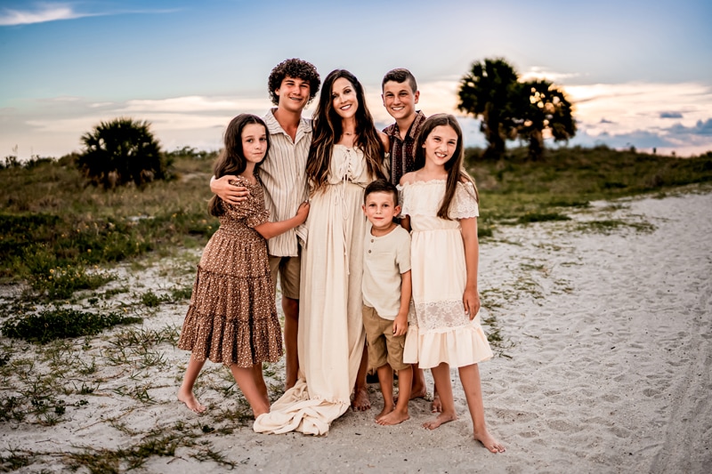 Salty/Moor Preset Pack, lightened and edited images, a mother is surrounded and embraces her 5 children, three sons, and two daughters at the beach