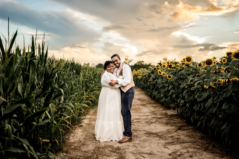 Salty Preset Pack, a man and woman smile and embrace on a path that separates a cornfield and a sunflower field