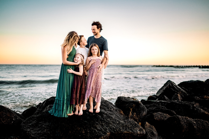 Salty Preset Pack, a young mother and father stand with their two daughters and son on ocean rocks at the sea