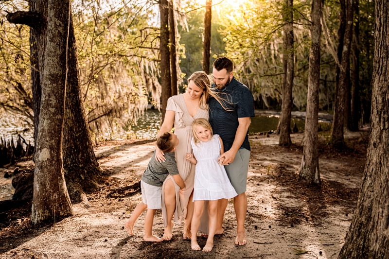 Salty Preset Pack, a small family of four embrace and laugh as they stand in the forest barefoot