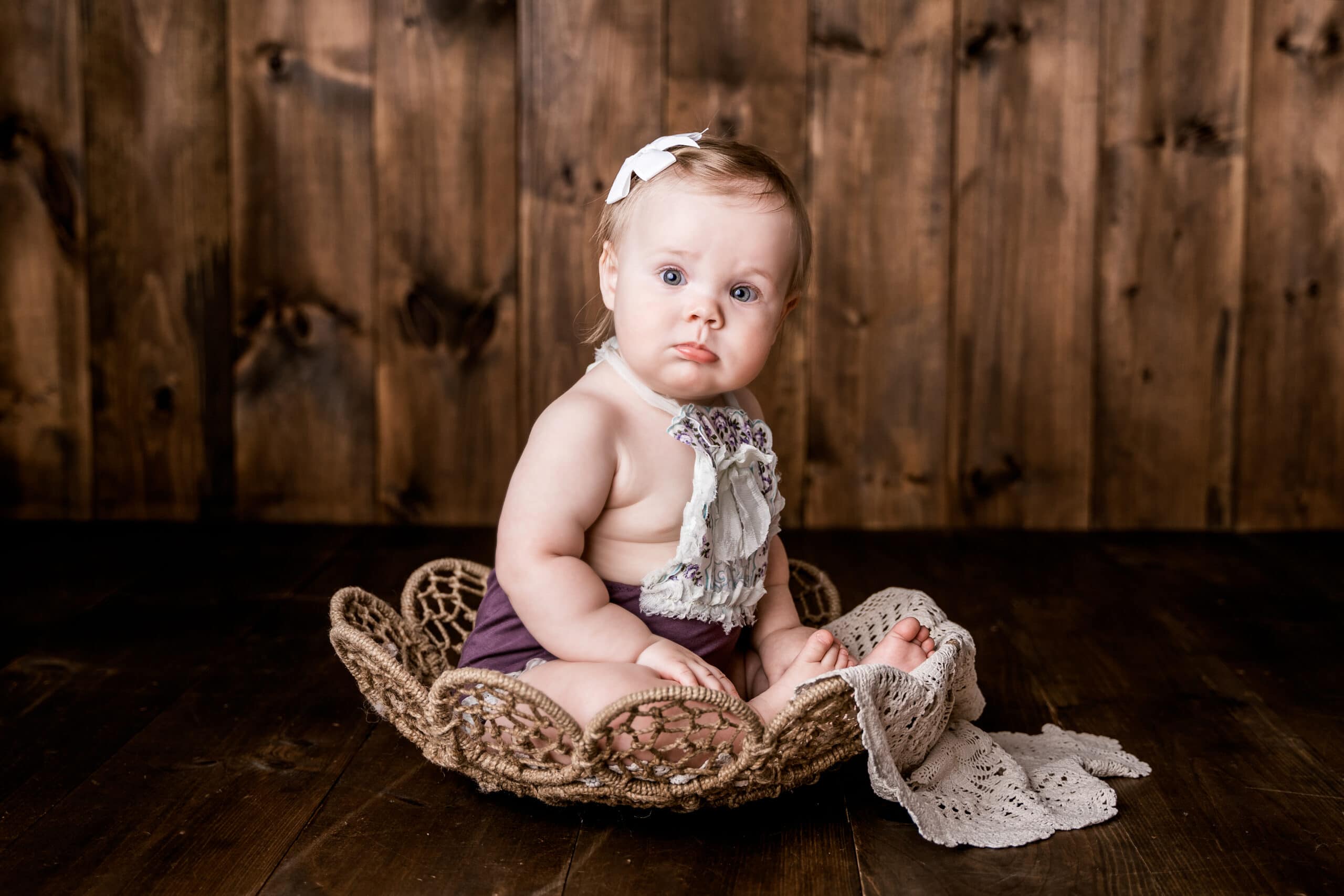 Moor Preset Pack, a lightened and edited image, a baby girl sits up in a small wicker basket