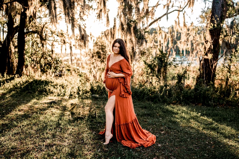 Salty Preset Pack, a pregnant and expecting mother stands beneath willow trees as the sun shines through them