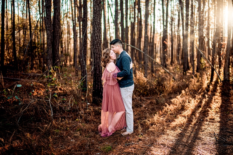 Salty Preset Pack, a man and woman embrace in the forest as the sun shines through the trees
