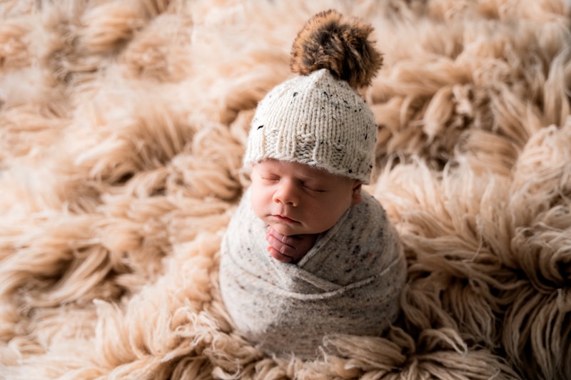 Moor Preset Pack, a baby sits up on a shag rug bundled in woven blankets and a beanie