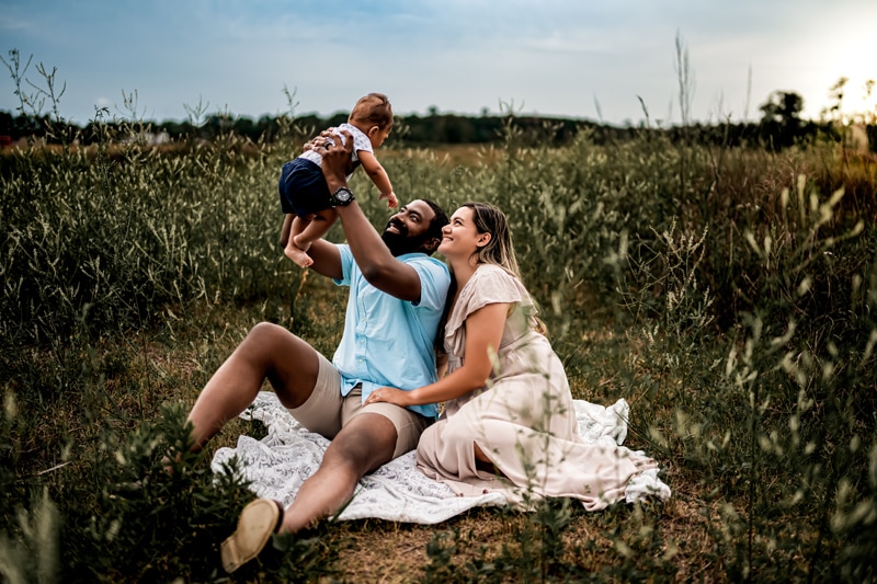 Salty Preset Pack, a man lifts his baby as mom leans into the man, the are in a grassy field