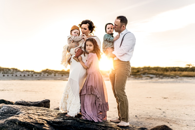 Salty Preset Pack, a mother and father hold their two babies as sister leans in at the beach