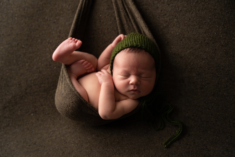 Moor Preset Pack, a baby sleeps in a blanket hammock and wears a knit beanie