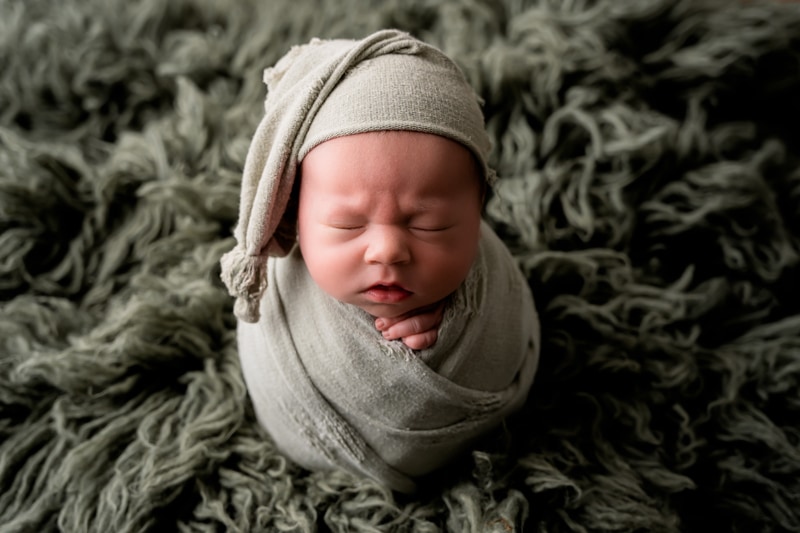 Moor Preset Pack, a baby is bundled in green blankets and lays on a green shag rug