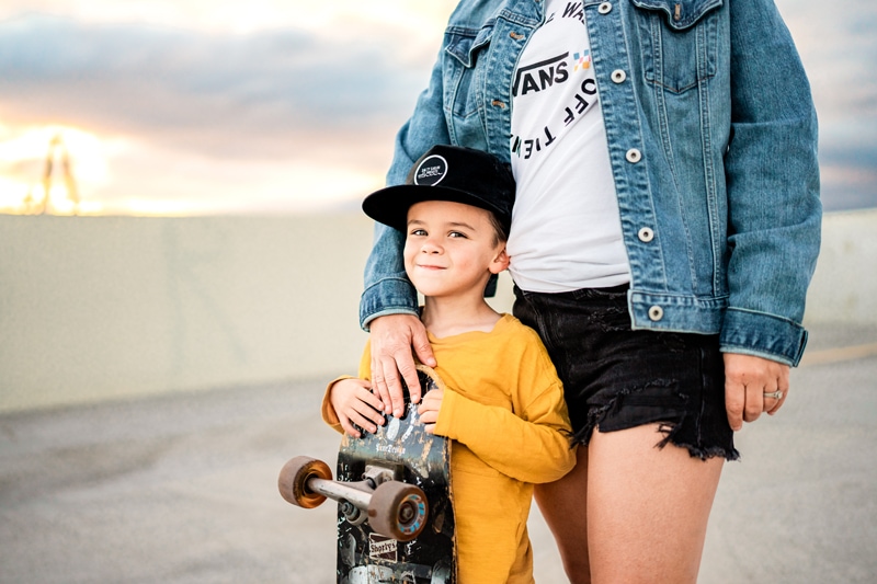 Salty Preset Pack, a mother has her arm around a little boy, he holds. a skateboard and is happy