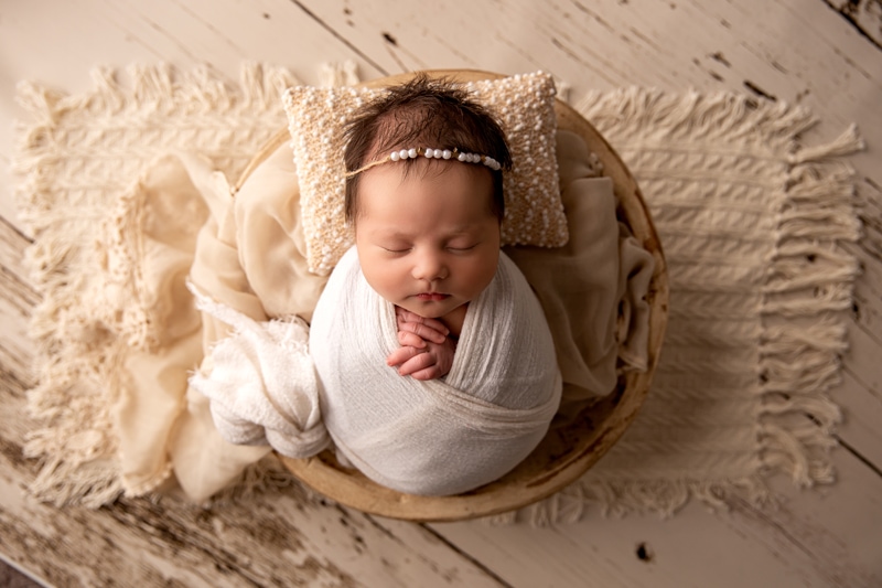 Moor Preset Pack,a baby girl is swaddled in a blanket and lays cozy in a wicker basket if linens