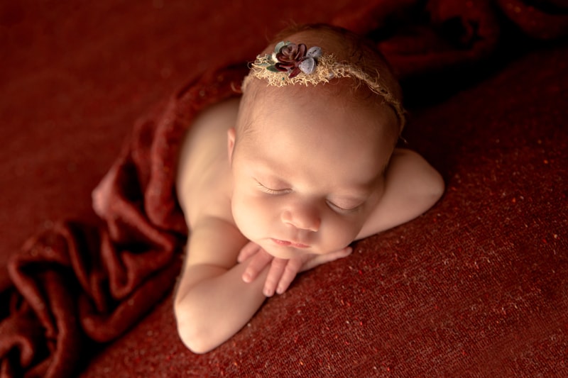Moor Preset Pack, a baby lays sleeping on woven blankets, headband on her head