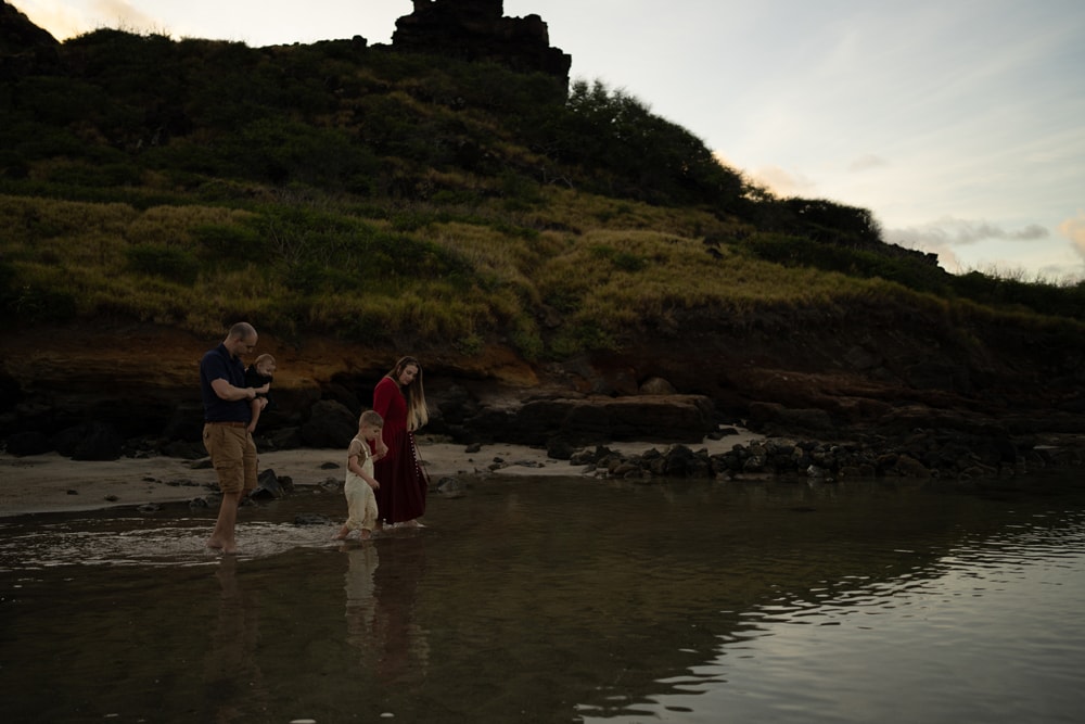 Dark unedited image, a man and woman embrace in ocean waters